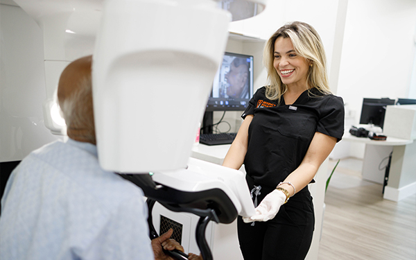 A Regency Square Dental clinician preparing a patient for a scan in the Davie office.